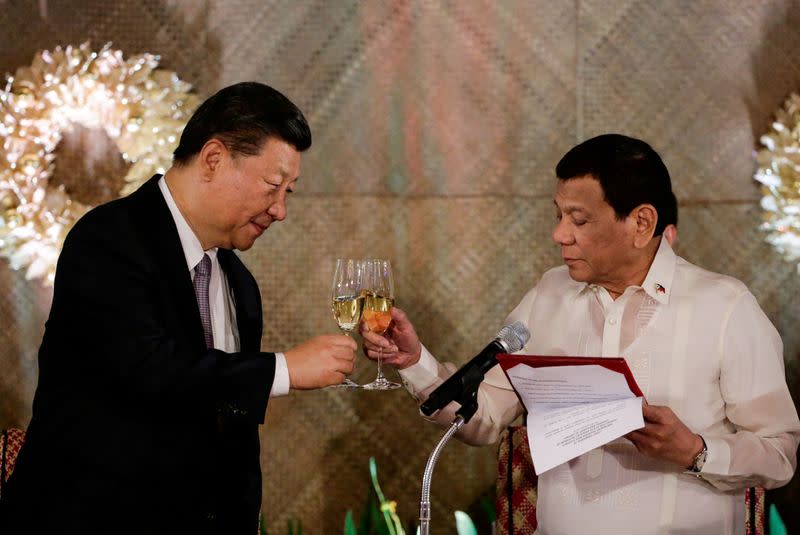 FILE PHOTO: China's President Xi Jinping and Philippine President Rodrigo Duterte toast during a State Banquet at the Malacanang presidential palace in Manila