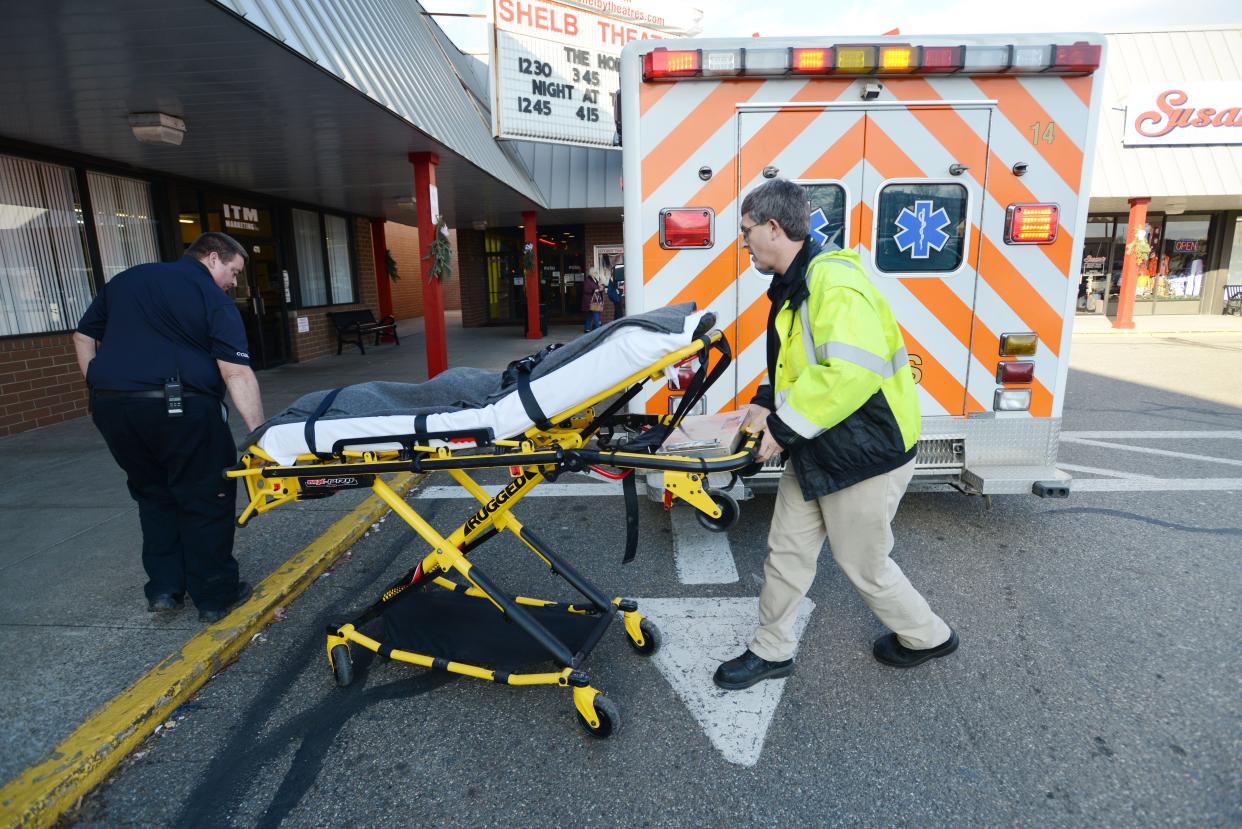 Brian Schuler and Todd Shroyer of Coshocton County Emergency Medical Services wheel a gurney into a store in this Tribune file photo. Shroyer, EMS Director, said his department is being hit hard right now by rising fuel prices, supply chain issues and general inflation.