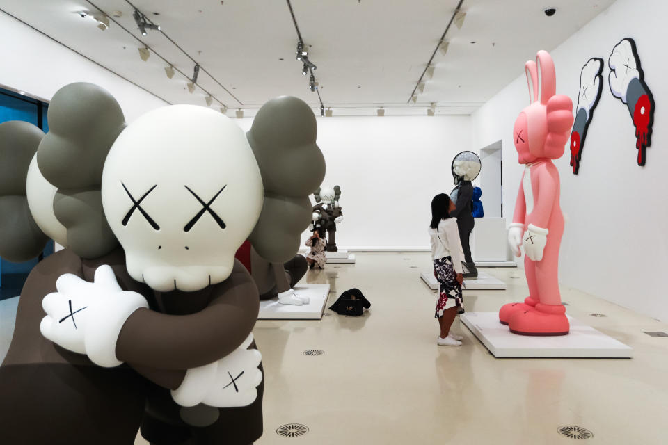 MELBOURNE, AUSTRALIA - SEPTEMBER 19: A visitor looks at a sculpture by KAWS during a media preview of KAWS: Companionship in the Age of Loneliness Exhibition Opening at National Gallery of Victoria at National Gallery of Victoria on September 19, 2019 in Melbourne, Australia. (Photo by Asanka Ratnayake/Getty Images)