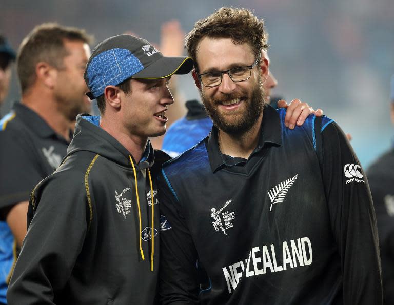 New Zealand's Matt Henry (L) and Daniel Vettori celebrate victory after their Cricket World Cup semi-final match against South Africa, at Eden Park in Auckland, on March 24, 2015