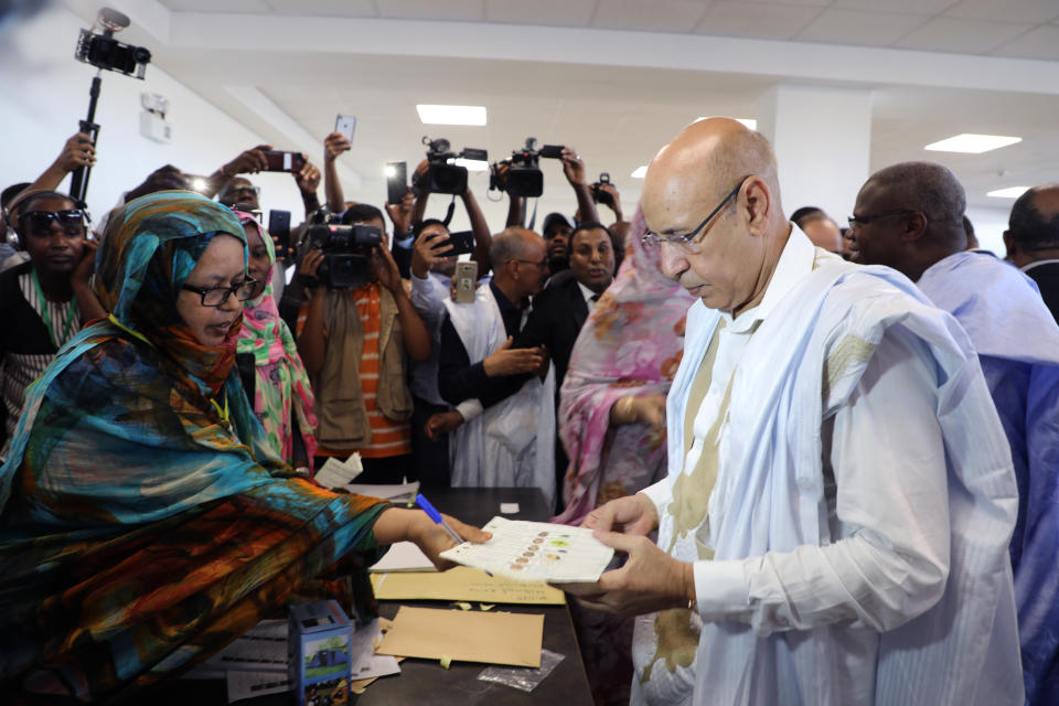 Ruling party presidential candidate and former Defense Minister Mohamed Ould El Ghazouani casts his ballot in Nouakchott, Mauritania, Saturday June 22, 2019. Mauritanians are choosing between outgoing President Mohamed Ould Abdel Aziz's heir apparent and five opposition candidates who believe the front-runner would represent a continuation of his rule in this West African country battling Islamic extremism. (AP Photo/Elhady Ould Mohamedou)