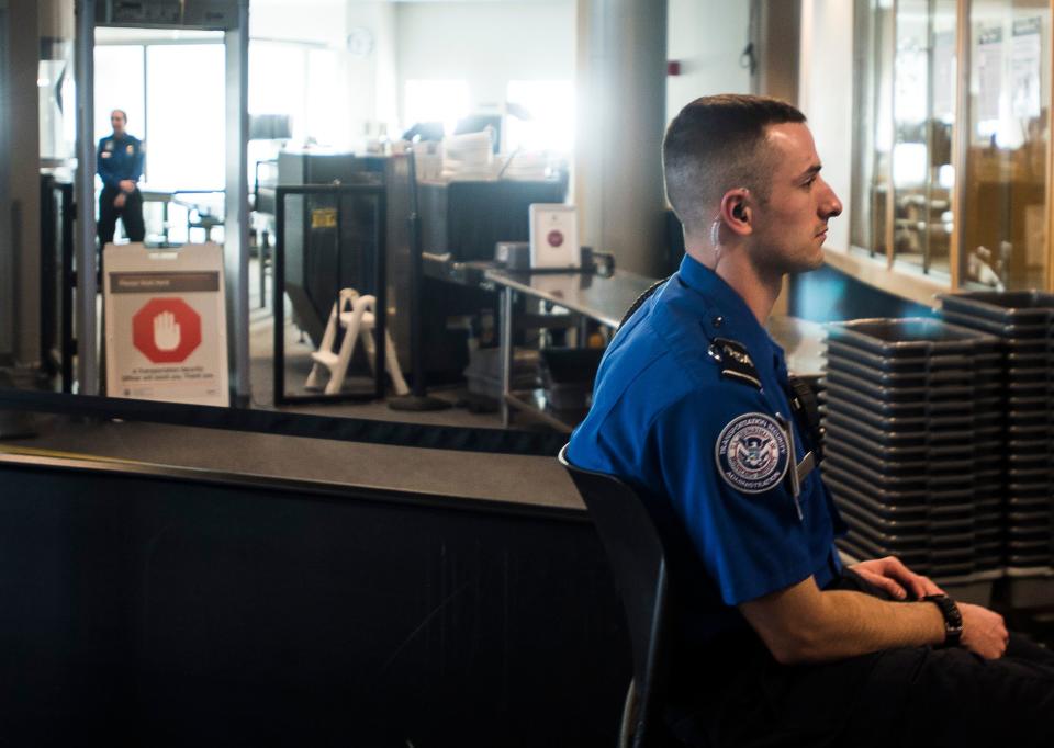 TSA agents at Burlington International Airport in South Burlington, VT, await passengers to screen at a security checkpoint on Friday, Jan. 11, 2019. Despite no paychecks going out, agents continued to report to work, according to airport Federal Security Director Bruce McDonald, but said that agents are working under mounting financial stress.