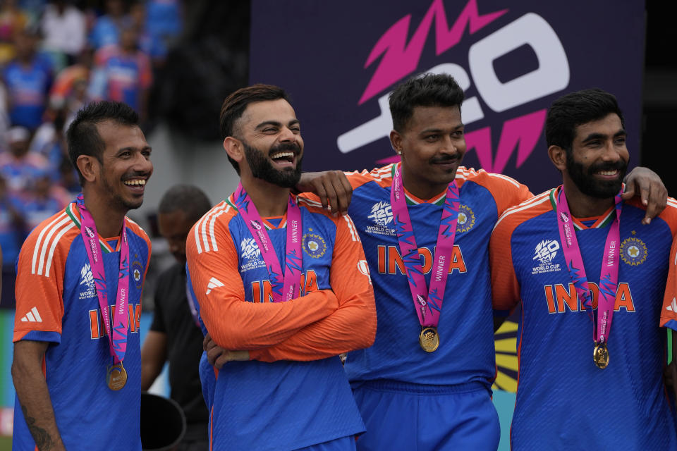 India's Virat Kohli, second left, shares a laugh with teammates at the presentation ceremony after defeating South Africa in the ICC Men's T20 World Cup final cricket match at Kensington Oval in Bridgetown, Barbados, Saturday, June 29, 2024. (AP Photo/Ricardo Mazalan)