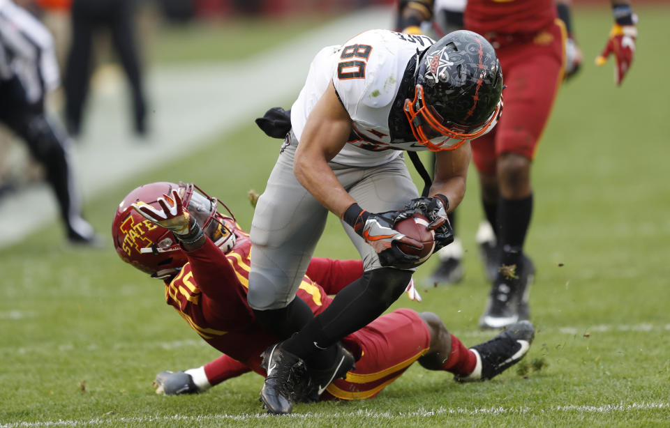 Oklahoma State wide receiver Tylan Wallace (80) is tackled by Iowa State defensive back Brian Peavy (10) after making a reception during the first half of an NCAA college football game, Saturday, Nov. 11, 2017, in Ames, Iowa. (AP Photo/Charlie Neibergall)