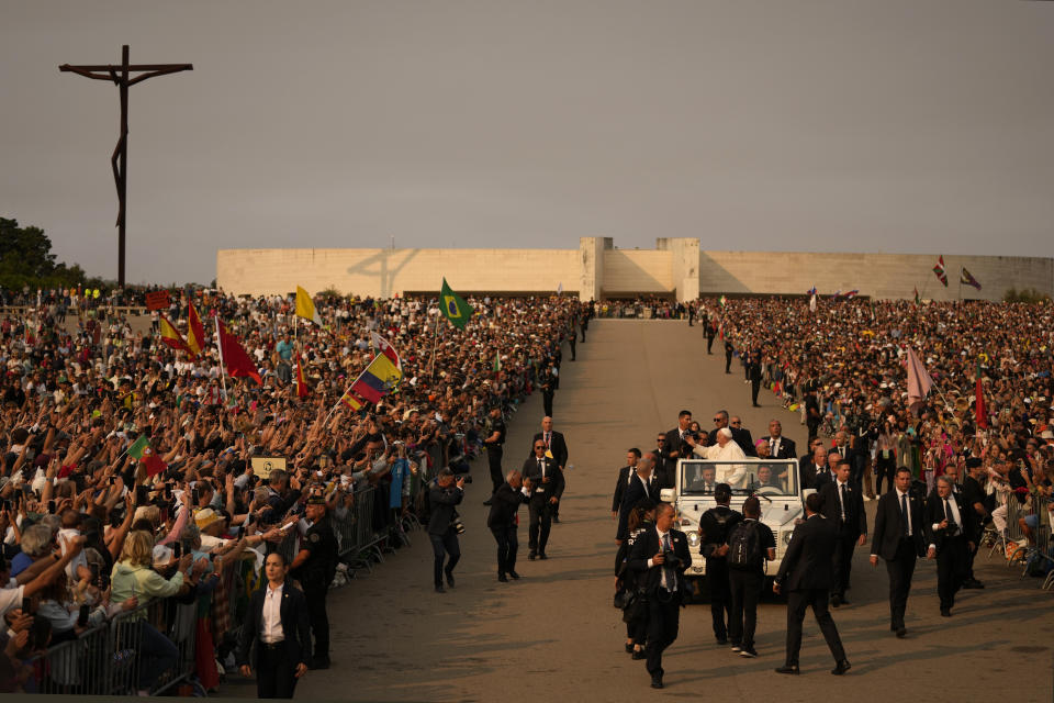 Pope Francis arrives surrounded by bodyguards at Our Lady of Fatima shrine in Fatima, central Portugal Saturday, Aug. 5, 2023. Pope Francis is in Portugal through the weekend into Sunday's 37th World Youth Day to preside over the jamboree that St. John Paul II launched in the 1980s to encourage young Catholics in their faith. (AP Photo/Francisco Seco)