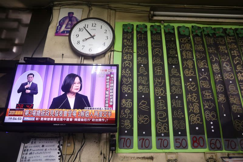 Taiwan President Tsai Ing-wen is seen on a TV screen during the third live policy address ahead of January's election, in Tainan