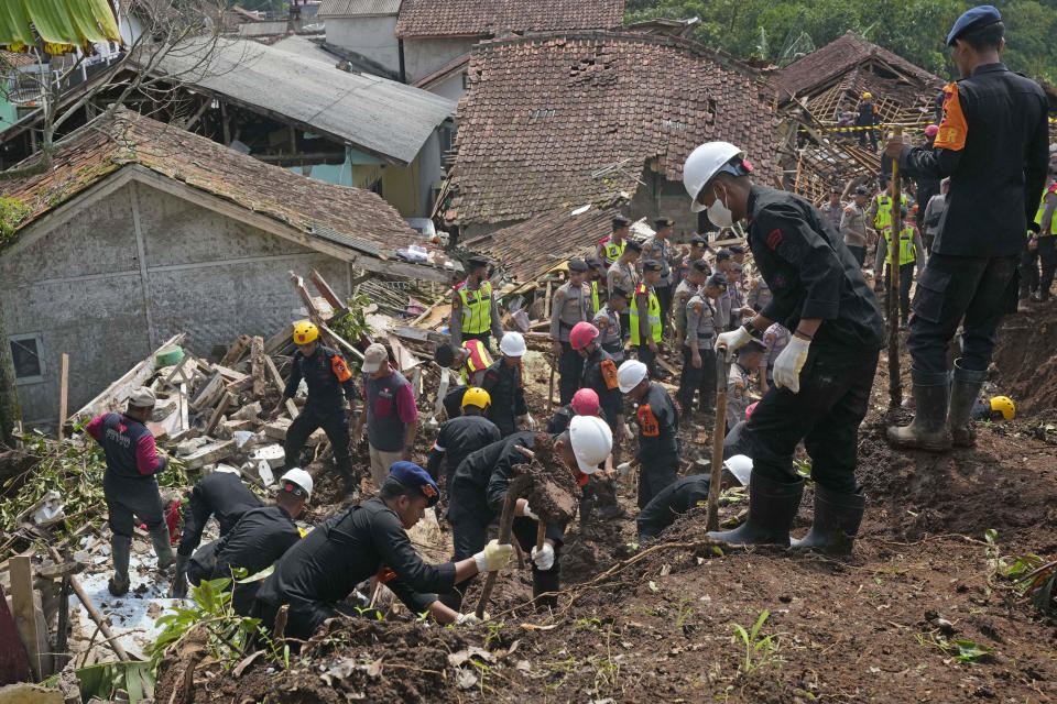 Rescuers search for victims at a village hit by an earthquake-triggered landslide in Cianjur, West Java, Indonesia, Thursday, Nov. 24, 2022. On the fourth day of an increasingly urgent search, Indonesian rescuers narrowed their work Thursday to the landslide where dozens are believed trapped after an earthquake that killed hundreds of people, many of them children. (AP Photo/Tatan Syuflana)