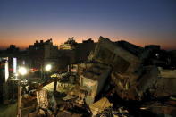 A 17-storey apartment building which collapsed after an earthquake is seen during sunset in Tainan, southern Taiwan, February 8, 2016. REUTERS/Tyrone Siu