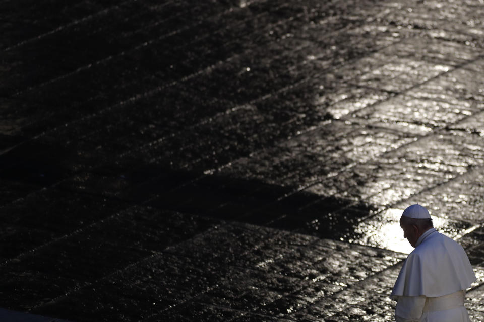 Pope Francis walks during Urbi and Orbi prayer (Latin for To the City and To the World) in an empty St. Peter's Square, at the Vatican, Friday, March 27, 2020. Praying in a desolately empty St. Peter's Square, Pope Francis on Friday likened the coronavirus pandemic to a storm laying bare illusions that people can be self-sufficient and instead finds “all of us fragile and disoriented” and needing each other's help and comfort. The new coronavirus causes mild or moderate symptoms for most people, but for some, especially older adults and people with existing health problems, it can cause more severe illness or death. (Yara Nardi/Pool Photo via AP)