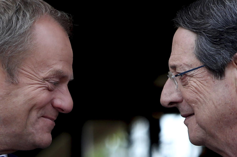 Cyprus' President Nicos Anastasiades, right, talks with European Council President Donald Tusk as he arrives for a meeting at the presidential palace in divided capital Nicosia, Cyprus, Friday, Oct. 11, 2019. Tusk is in Cyprus for one-day visit. (AP Photo/Petros Karadjias)