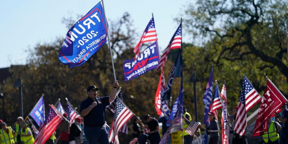 In this Jan. 6, 2021 file photo, people attend a rally in support of President Donald Trump outside Thousand Oaks City Hall in Thousand Oaks, Calif.