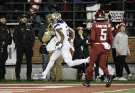 Washington wide receiver Ja'Lynn Polk (2) runs for a touchdown near Washington State defensive back Derrick Langford Jr. (5) during the first half of an NCAA college football game, Saturday, Nov. 26, 2022, in Pullman, Wash. (AP Photo/Young Kwak)