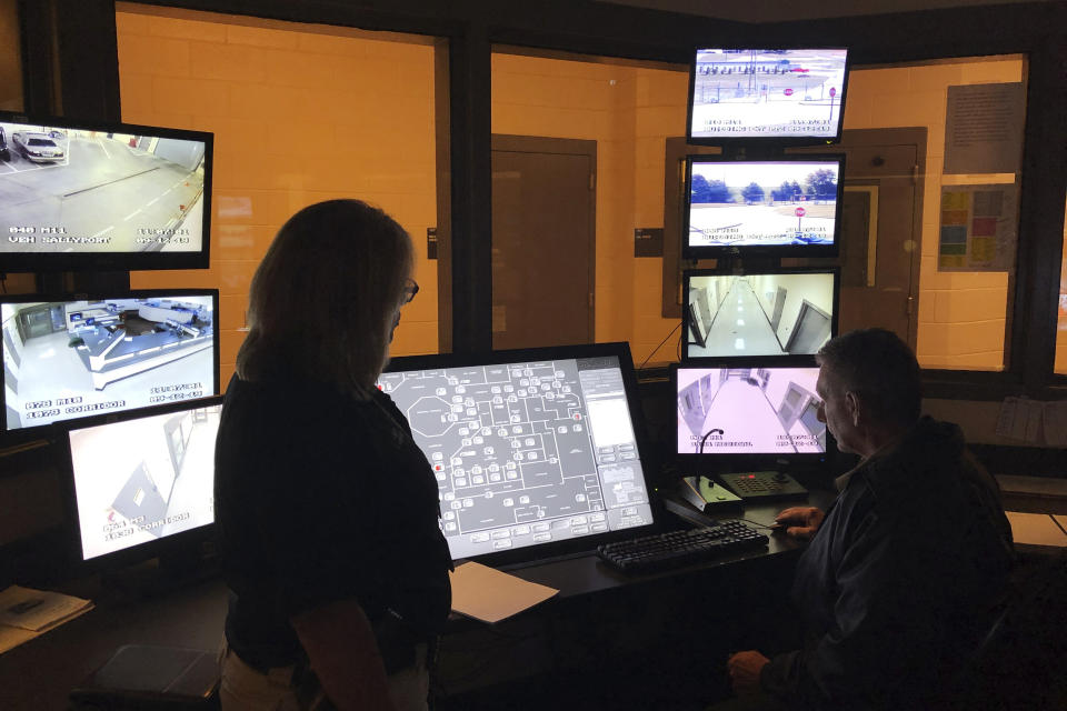 In this Sept. 12, 2019 photo, County Sheriff Janis Mangum stands in a control room at the county jail, in Jefferson, Ga. A ransomware attack in March took down the office's computer system, forcing deputies to handwrite incident reports and arrest bookings. (AP Photo/Sudhin Thanawala)