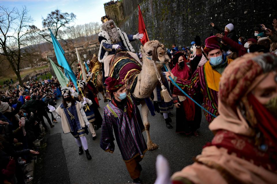 One king of The Cabalgata Los Reyes Magos (Cavalcade of the three kings) waves to people during the Cabalgata Los Reyes Magos (Cavalcade of the three kings) during the cavalcade the day before Epiphany, in Pamplona, northern Spain, Wednesday, Jan. 5, 2022.