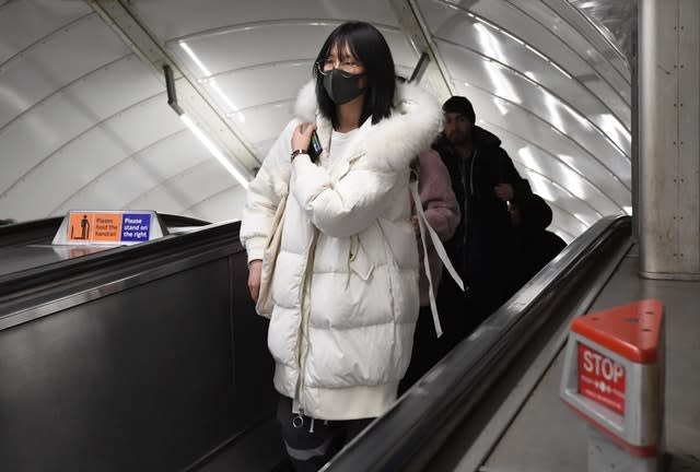 A women wearing a face mask at Leicester Square tube station (Kirsty O’Connor/PA)