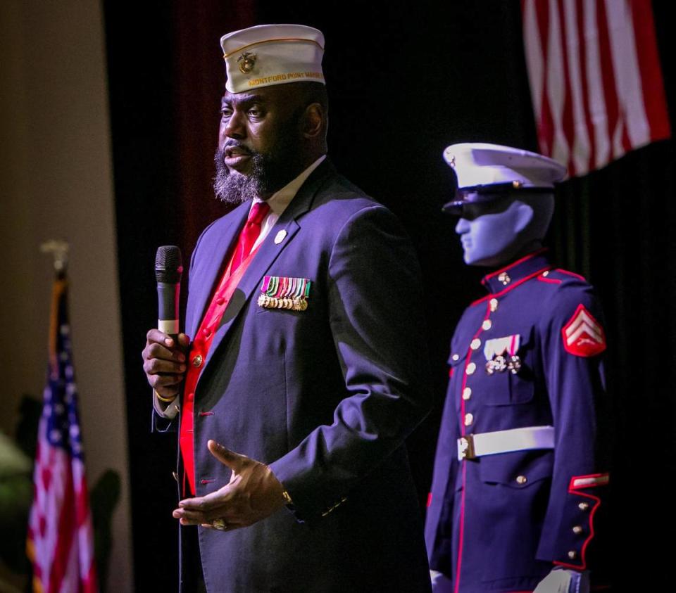 James T. Averhart, national president of the Montford Point Marine Association, speaks to guests at a Congressional Gold Medal ceremony held at the African American Research Library and Cultural Center in Fort Lauderdale Monday, Feb. 6, 2023. In the background is Cpl. George J. Johnson’s uniform decorated with medals he was awarded during the ceremony. Johnson, a 101-year-old former Marine was honored for being among the first Black recruits allowed to enlist in the U.S. Marine Corps in the early 1940s.