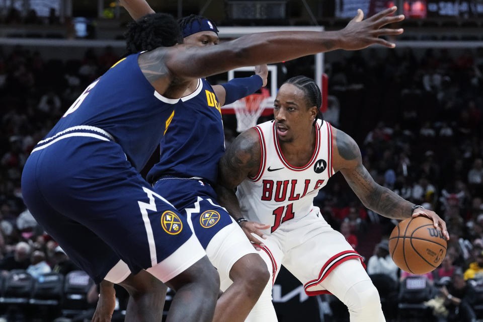 Chicago Bulls forward DeMar DeRozan, right, works against Denver Nuggets forward Peyton Watson, center, and center DeAndre Jordan during the second half of an NBA preseason basketball game in Chicago, Thursday, Oct. 12, 2023. (AP Photo/Nam Y. Huh)