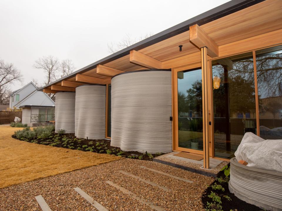 Icon's over 2,000-square-foot House Zero in Austin. The exterior of the home is made of layered printed concrete that hold up the wooden roof.