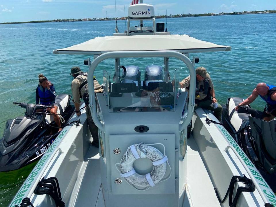 Florida Fish and Wildlife Conservation Commission Officers Jason Rafter and Bobby Dube conduct a safety check with two people riding personal watercraft on Florida Bay in Islamorada Sunday, May 30, 2021.