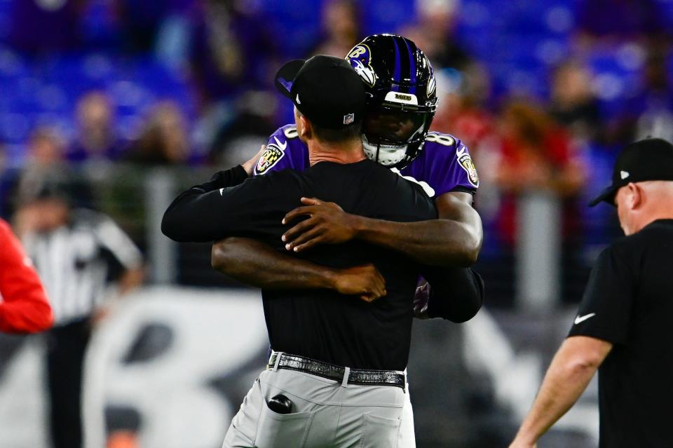 Baltimore Ravens head coach John Harbaugh speaks with  quarterback Lamar Jackson (8) before the game against the Kansas City Chiefs at M&T Bank Stadium.