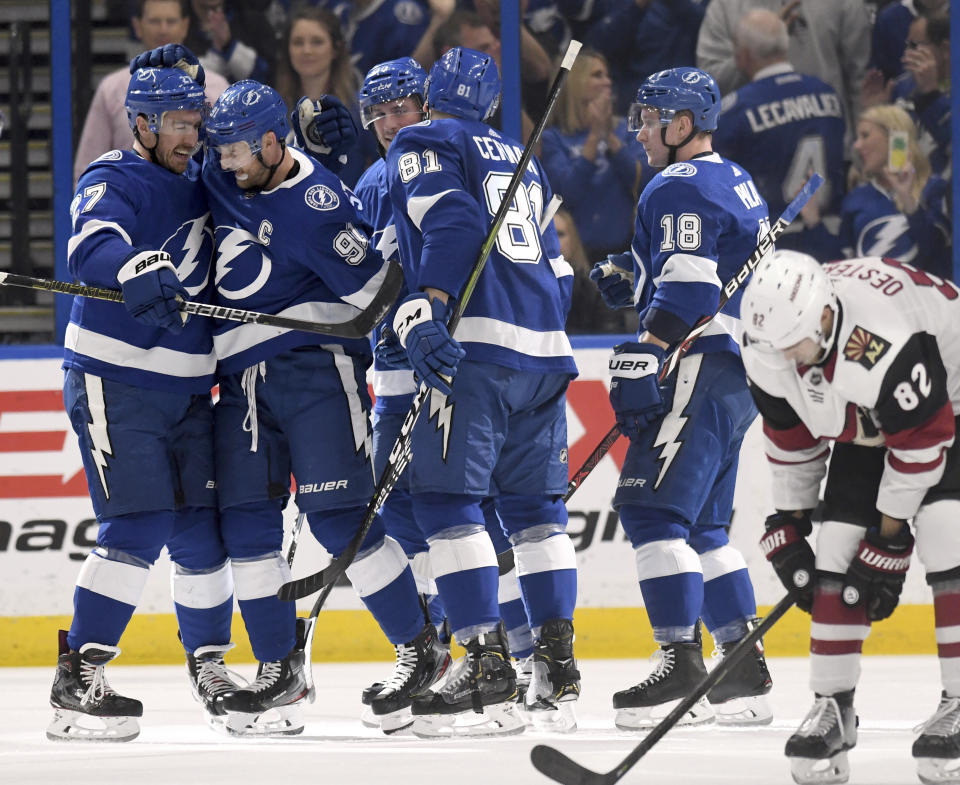 Tampa Bay Lightning defenseman Ryan McDonagh (27), center Steven Stamkos (91), defenseman Erik Cernak (81) and left wing Ondrej Palat (18) celebrate Stamkos' goal during the first period of an NHL hockey game against the Arizona Coyotes Monday, March 18, 2019, in Tampa, Fla. (AP Photo/Jason Behnken)