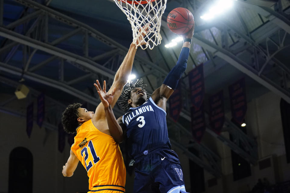 Villanova's Brandon Slater, right, goes up for a shot against La Salle's Clifton Moore during the first half of an NCAA college basketball game, Sunday, Nov. 28, 2021, in Philadelphia. (AP Photo/Matt Slocum)