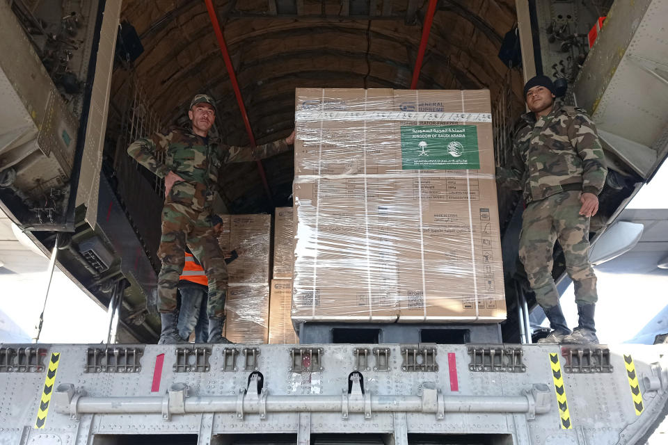In this photo released by the official Syrian state news agency SANA, Syrian soldiers unload humanitarian aid sent from Saudi Arabia for Syria following a devastating earthquake, at the airport in Aleppo, Syria, Tuesday, Feb. 14, 2023. The first Saudi plane carrying 35 tons of food aid landed in government-held Aleppo airport Tuesday morning, according to Syrian state media. Saudi Arabia, unlike most other Arab countries including the United Arab Emirates, have not rekindled ties with embattled Syrian President Bashar Assad in recent years. (SANA via AP)