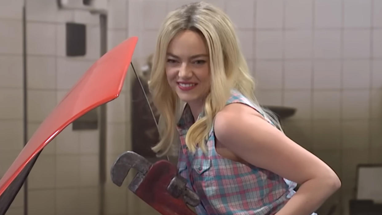  Screenshot of Emma Stone as sexy mechanic poster girl in Saturday Night Live sketch. 