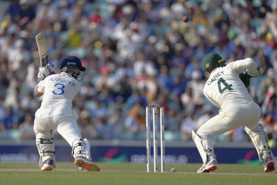 India's Ajinkya Rahane looks round as the ball jumps up past Australia's Alex Carey off the bowling of Australia's Nathan Lyon on the fourth day of the ICC World Test Championship Final between India and Australia at The Oval cricket ground in London, Saturday, June 10, 2023. (AP Photo/Kirsty Wigglesworth)