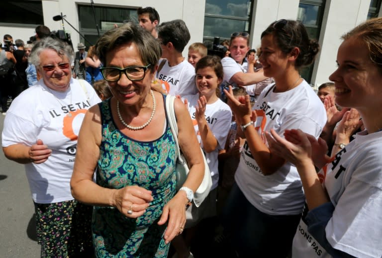Viviane Lambert (2nd L), the mother of Vincent Lambert, is applauded by members of the support committee campaigning for Vincent to be kept alive, on July 23, 2015