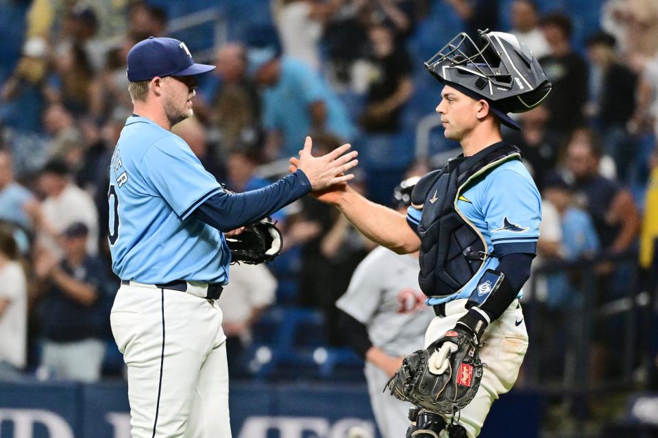 Tampa Bay Rays catcher Ben Rortvedt, right, and pitcher Garrett Cleavinger celebrate after defeating the Detroit Tigers, 7-5, at Tropicana Field on April 24.