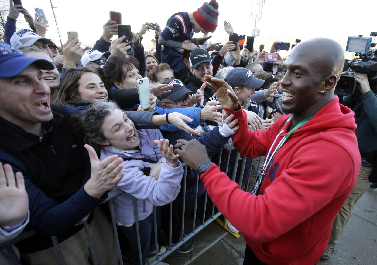 Patriots free safety Devin McCourty, right, greets fans following the football teams arrival at Gillette Stadium after Super Bowl LIII. (AP)