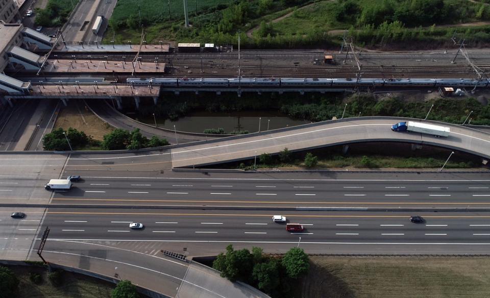 Drone image of a NJ Transit train pulling out of Secaucus Junction as traffic passes on the New Jersey Turnpike on Thursday, June 25, 2020, in Secaucus. Gov. Phil Murphy announced Wednesday that full NJ Transit train and light rail service will resume on July 6.