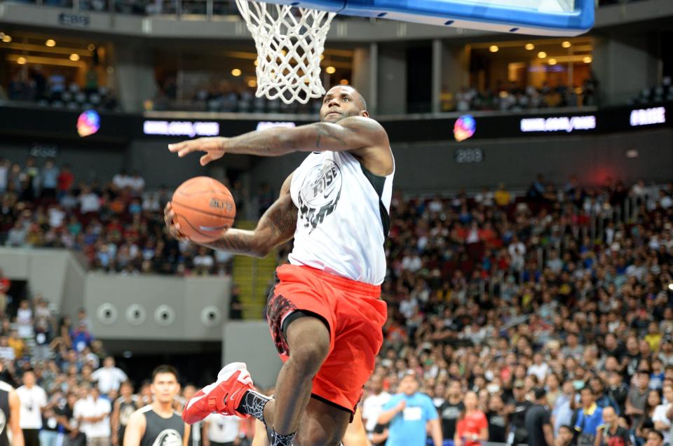 US NBA superstar LeBron James plays during an exhibition game as part of a clinic session in Manila on August 20, 2015. James is here to conduct basketball clinic to select talented baskeball players from disadvantaged families.    AFP PHOTO / TED ALJIBE        (Photo credit should read TED ALJIBE/AFP/Getty Images)