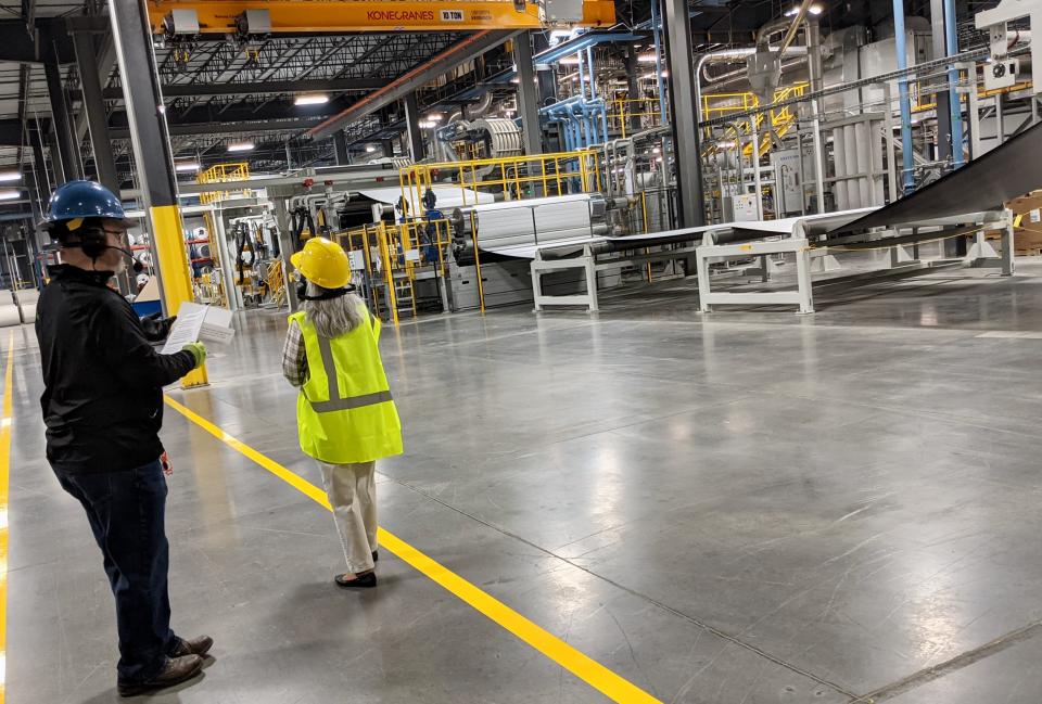 Jared Foster, maintenance planner at IKO's new manufacturing facility near Hagerstown, leads Linda Spence of the Washington County Department of Business Development on a tour of the facility on May 12, 2022.