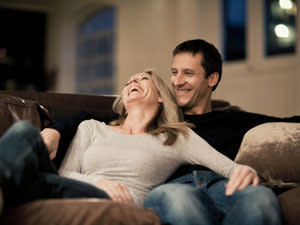 couple laughing on couch