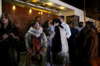 Relatives gather outside the residence of Junaid Jamshed, pop star turned evangelical Muslim cleric, in Karachi, Pakistan December 7, 2016. REUTERS/Akhtar Soomro