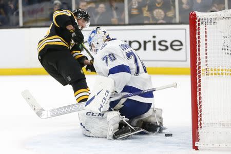 Feb 28, 2019; Boston, MA, USA; Boston Bruins left wing Brad Marchand (63) scores a goal past Tampa Bay Lightning goaltender Louis Domingue (70) during the third period at TD Garden. Mandatory Credit: Greg M. Cooper-USA TODAY Sports