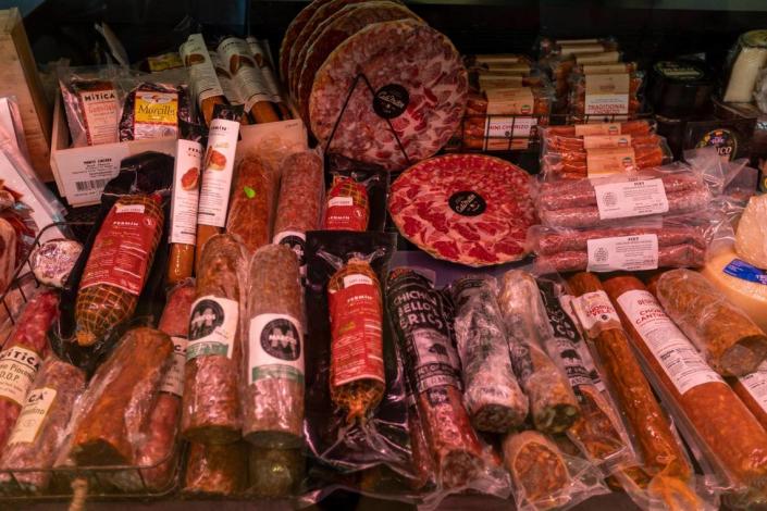 Spanish ham, chorizos, cheese and other meats for sale at the market at CalaMillor Gourmet Experience in Miami.