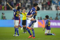 Japan players jubilate at the end of the World Cup group E soccer match between Japan and Spain, at the Khalifa International Stadium in Doha, Qatar, Thursday, Dec. 1, 2022. Japan won 2-1. (AP Photo/Julio Cortez)