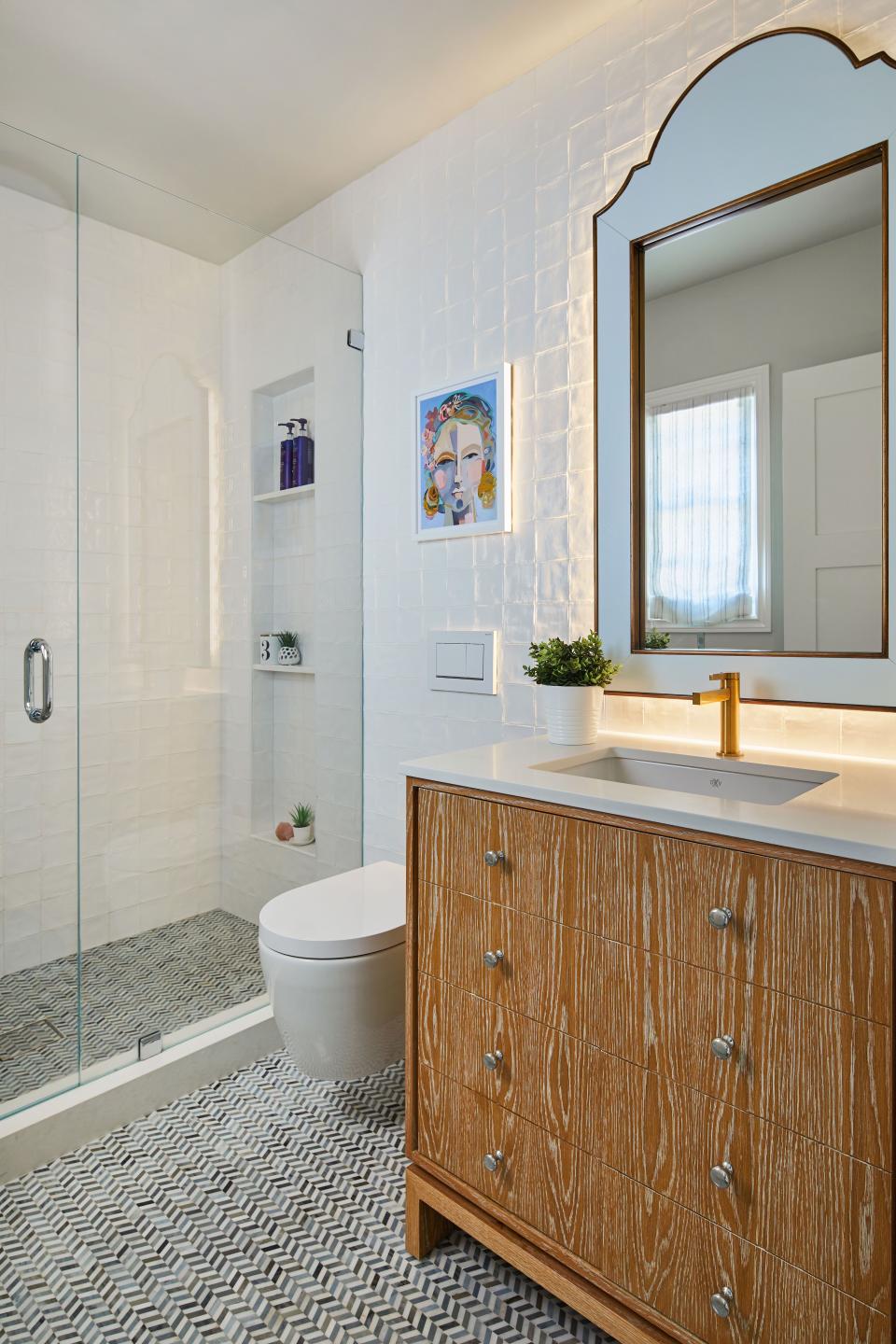 The couple’s teenage daughter, Loy, had a say in what pieces ended up in her bathroom, from the art to the blue mirror. The vanity only looks like drawers; those are actually double doors to increase storage for her favorite Lush bath products and her mini skin-care refrigerator.