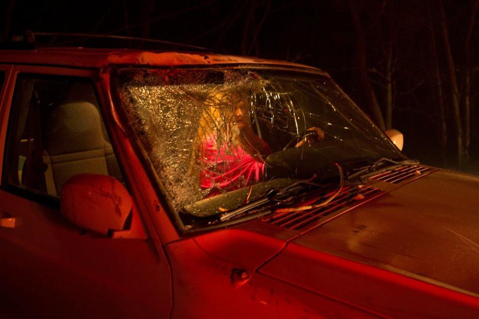 The unidentified driver who narrowly survived after a large tree fell on to the road and cracked the windshield during the Camp Fire, as it burned out of control through Paradise, Calif. on Nov. 8.