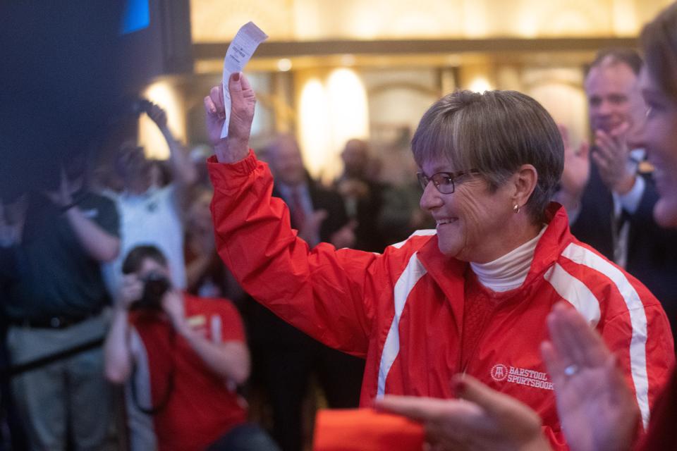 Sporting an official Barstool Sportsbook jacket, Kansas Gov. Laura Kelly waves her receipt for her $15 bet on the Kansas City Chiefs to win the 2022 Super Bowl at Hollywood Casino.