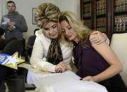 Summer Zervos, a former contestant on the TV show The Apprentice, is embraced by lawyer Gloria Allred (L) while speaking about allegations of sexual misconduct against Donald Trump during a news conference in Los Angeles, California, U.S. October 14, 2016. REUTERS/Kevork Djansezian
