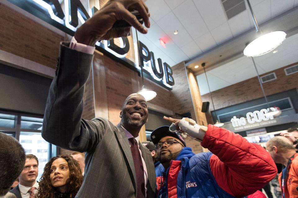 John Salley takes a selfie with a Pistons fan before the Pistons-Trail Blazers game at the Little Caesars Arena in Detroit, Saturday, March 30, 2019.