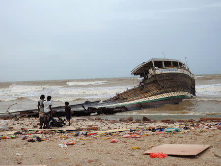 People search among the wreckage of a boat destroyed by Cyclone Mekunu in Socotra Island, Yemen, May 25, 2018. REUTERS/Stringer