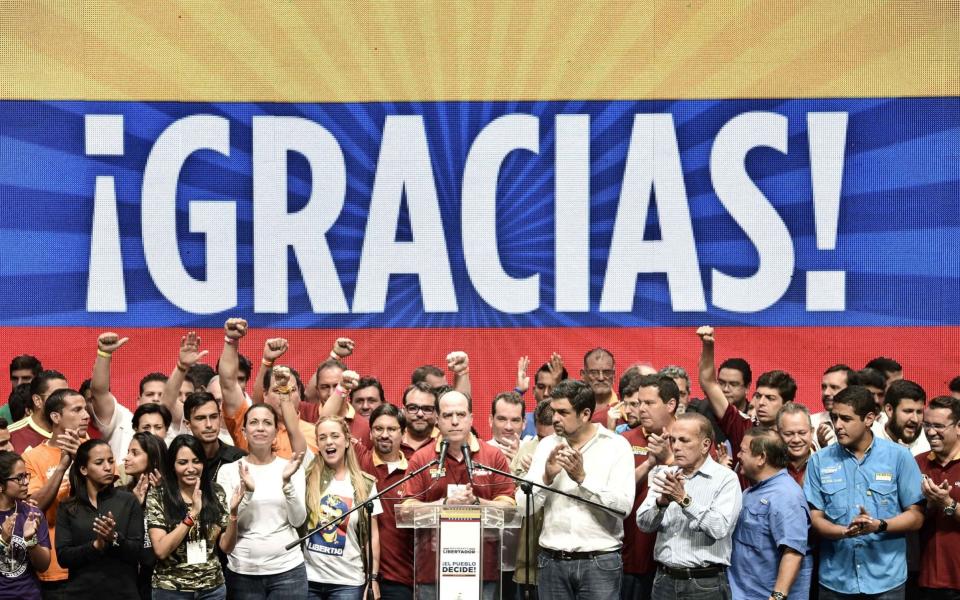 Julio Borges, president of Venezuela's National Assembly, center, gives a speech as lawmakers and opposition leaders celebrate after the result announcement of a symbolic Venezuelan plebiscite at the opposition alliance's headquarters in the Chacao municipality of Caracas, Venezuela, on Monday, July 17, 2017 - Credit: Bloomberg