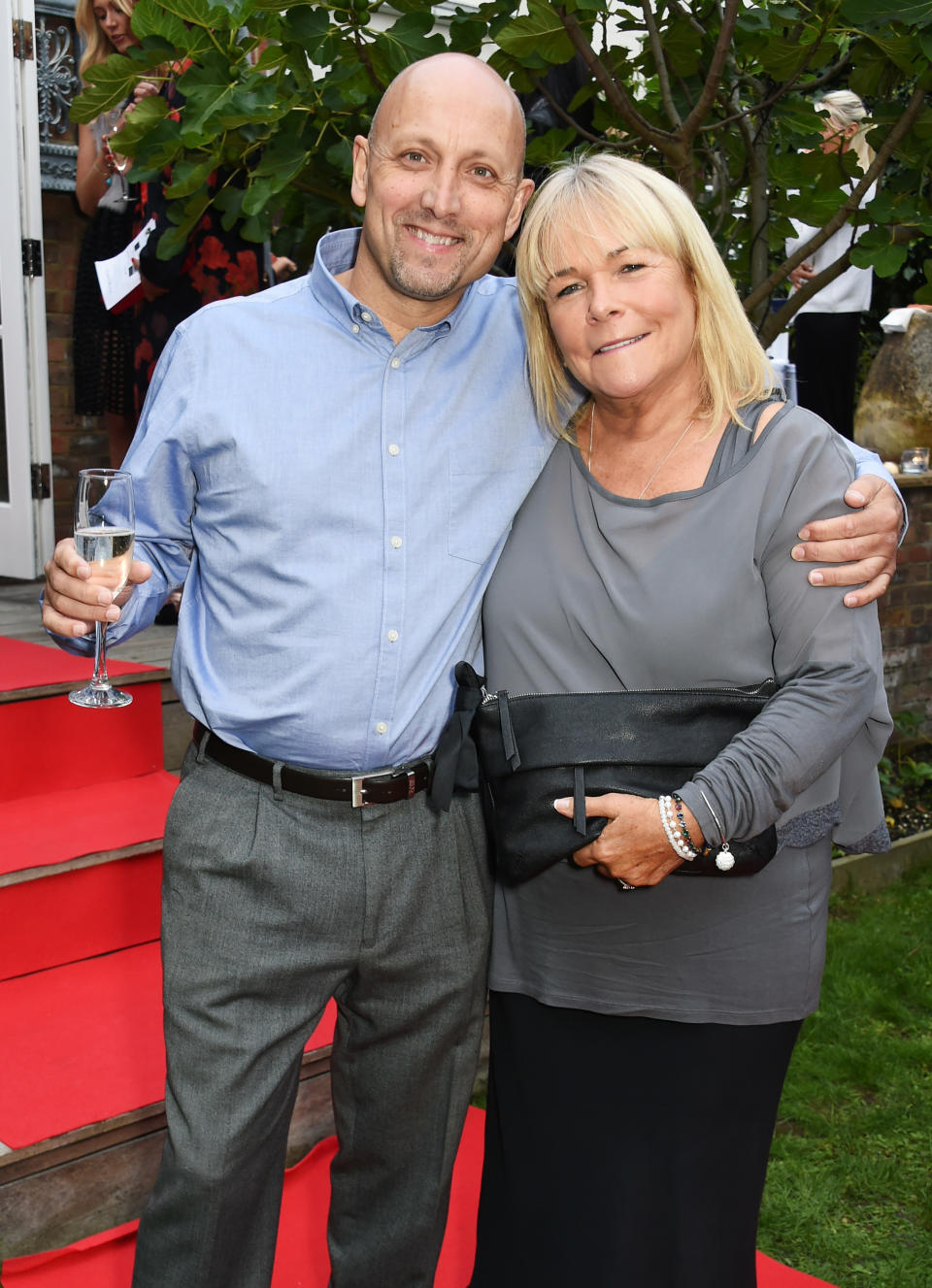 Mark Dunford (L) and Linda Robson attend Kelly Simpkin London's fashion soiree garden party in support of the British Red Cross at the home of Kelly Simpkin and Nicky Clarke on September 4, 2015 in London, England.  (Photo by David M. Benett/Dave Benett/Getty Images)