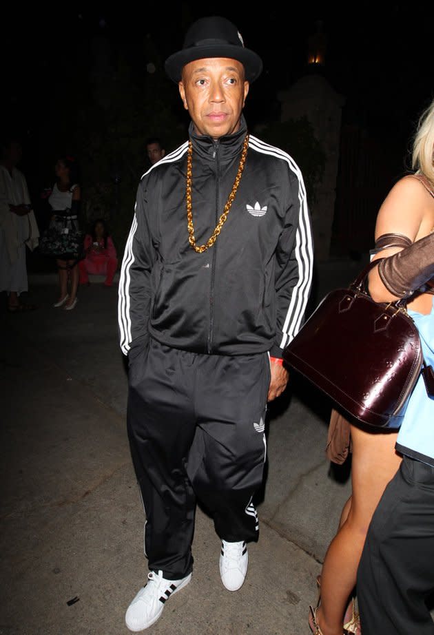 Russell Simmons took a cue from his younger brother Joseph "Run" Simmons by dressing as one of the guys from Run-D.M.C. The music and fashion mogul wore a track suit, heavy gold chain, and the Adidas sneaks for which the rap group was famous as he hit up the Halloween bash at the Playboy Mansion in L.A. on Saturday. (10/27/2012)