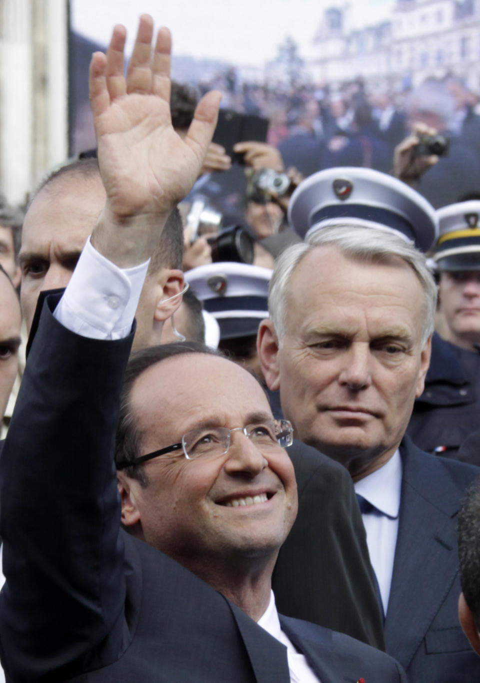 France's new President Francois Hollande followed by his new prime minister, Jean-Marc Ayrault, right, leaves the Paris city hall after attending a traditional ceremony on the day of his investiture in Paris, Tuesday, May 15, 2012. (AP Photo / Pascal Rossignol, Pool)